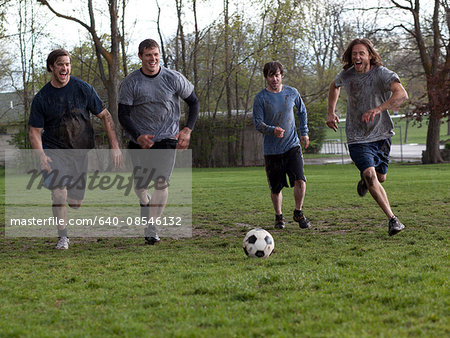 USA, Utah, Provo, Four friends playing football