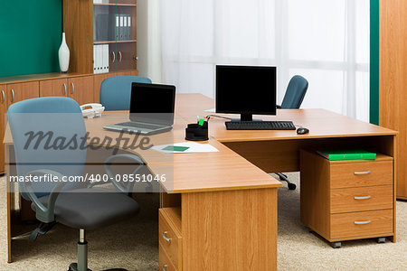 computer and laptop on a desk at modern office