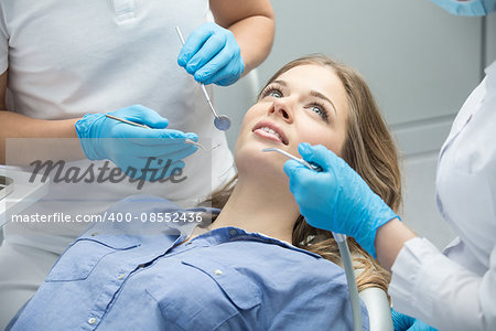 Girl with beautiful white teeth on reception at the doctor dentist.