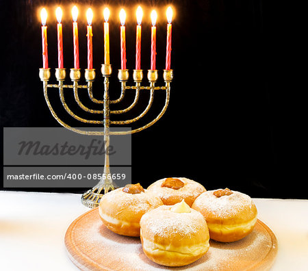 image of jewish holiday Hanukkah with menorah and doughnuts
