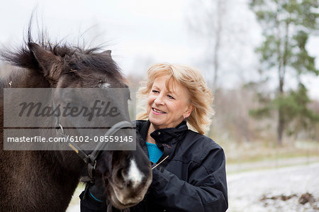 Senior woman with Icelandic horse
