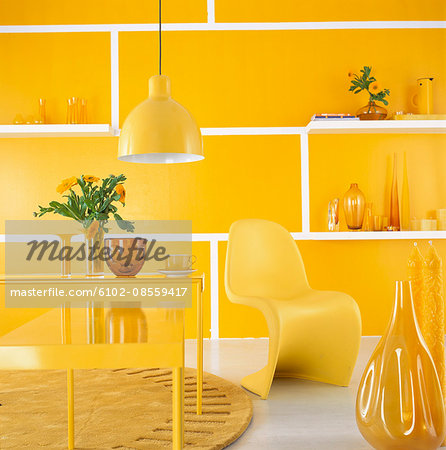 Decorated room with yellow furniture and wall.