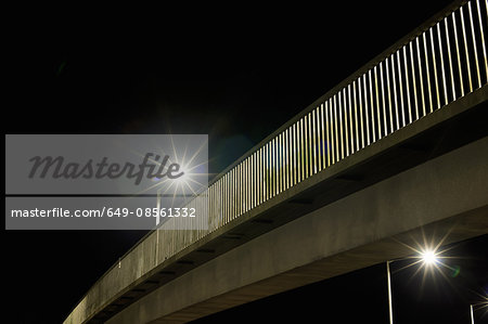 Streetlights on urban bridge