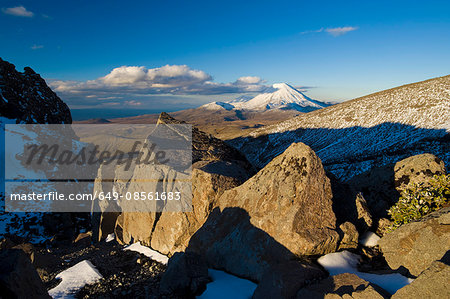 Shadows over rocks in snowy landscape