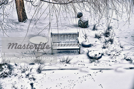 Bench and table on snowy street