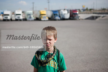 Boy with snake around his neck