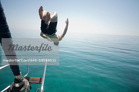 Man jumping head first into the sea