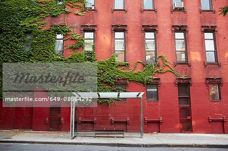 Bus stop and red brick building, New York City, USA