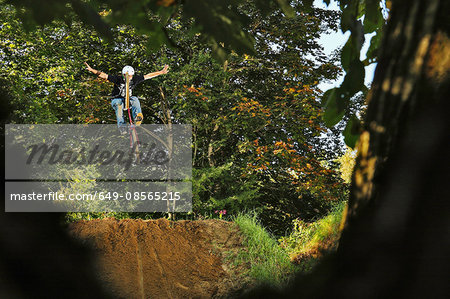 BMX rider mid air with arms outstretched