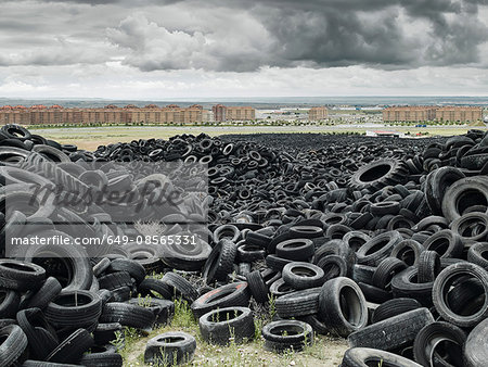 Pile of old tyres outside of city