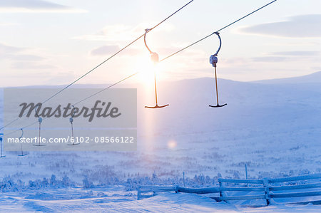 T-bars of ski lift hanging over snowy hill