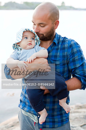 Mid adult man holding baby