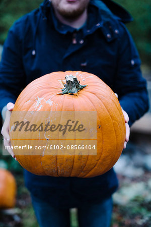 Man holding pumpkin