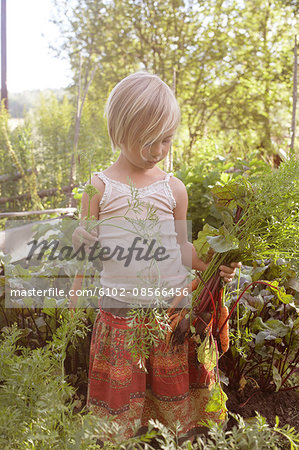 Girl holding vegetables