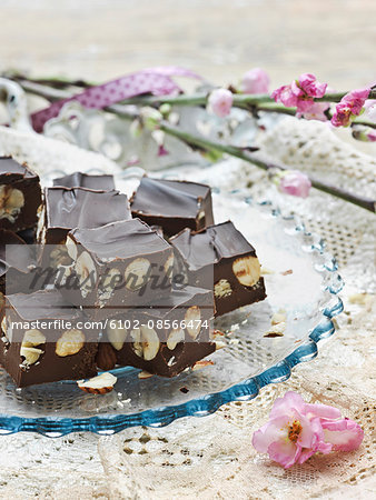 Chocolate and nut sweets on glass plate