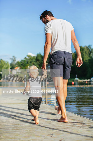 Father with walking on jetty