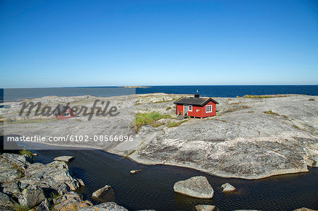 Wooden houses on rocky coast