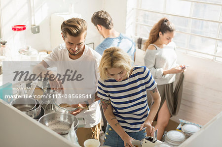 College student roommates sharing morning kitchen