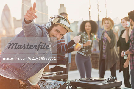 Portrait enthusiastic DJ gesturing at rooftop party