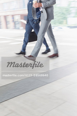Corporate businessmen walking with coffee