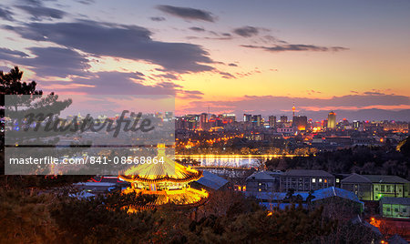 Illuminated pagoda and view towards the western part of Beijing city at nightfall, Beijing, China, Asia