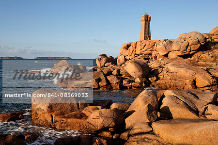 Lighthouse and pink rocks at sunset, Ploumanach, Cote de Granit Rose, Cotes d'Armor, Brittany, France, Europe