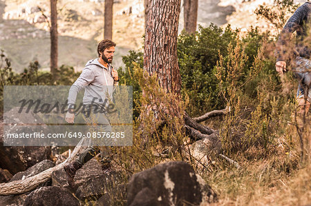 Male hiker hiking on forest rock formation, Deer Park, Cape Town, South Africa