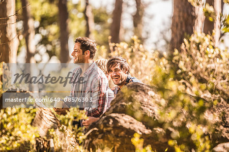 Two male hikers sitting drinking coffee in forest, Deer Park, Cape Town, South Africa