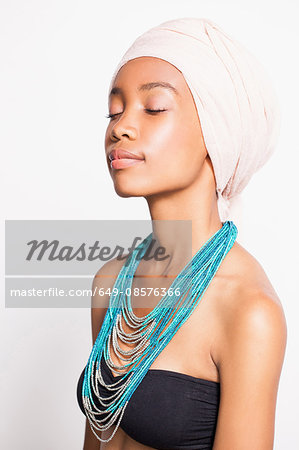 Portrait of woman wearing headscarf and statement necklace