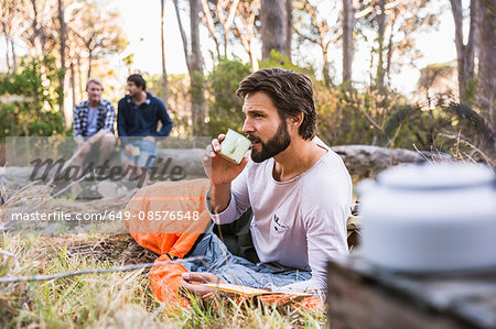 Man in sleeping bag drinking coffee, Deer Park, Cape Town, South Africa