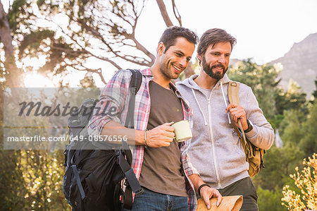 Two male hikers preparing for hike in forest, Deer Park, Cape Town, South Africa