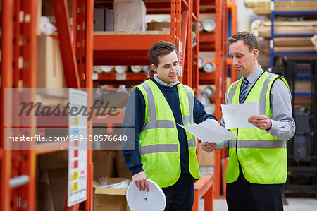 Manager training factory worker in factory warehouse