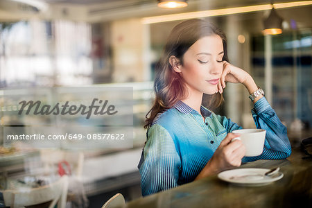Beautiful woman at cafe window seat, Dubai, United Arab Emirates Beautiful woman at cafe window seat, Dubai, United Arab Emirates