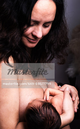 Mid adult woman breastfeeding baby son