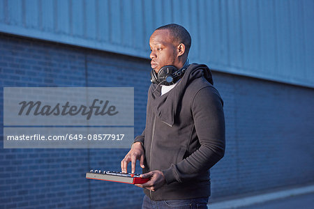 Man with headphones using handheld keyboard