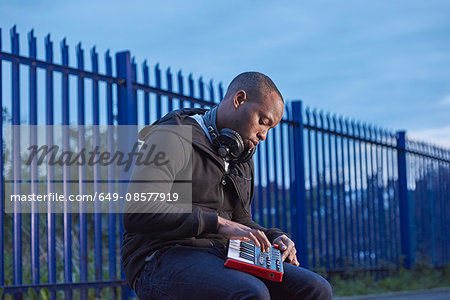 Man with headphones using handheld keyboard