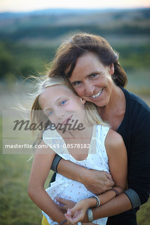 Portrait of senior woman hugging granddaughter, Buonconvento, Tuscany, Italy