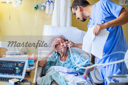 Hospital staff checking on patient on hospital bed