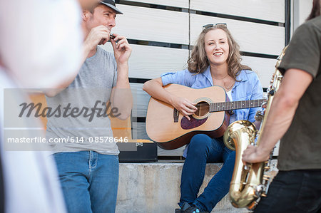 Three street musicians playing together