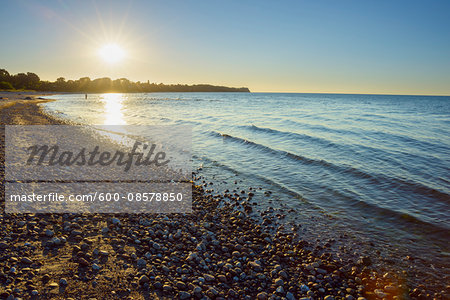 Pebble beach with Sun in Summer, Sunset, Dronningmolle, Hovedstaden, Baltic Sea, Zealand, Denmark