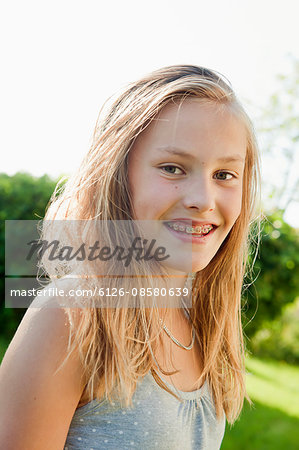 Sweden, Bohuslan, Portrait of girl (12-13) in braces smiling