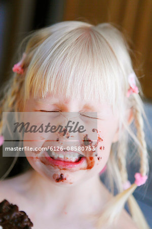 Sweden, Portrait of girl (4-5) with face dabbed with chocolate