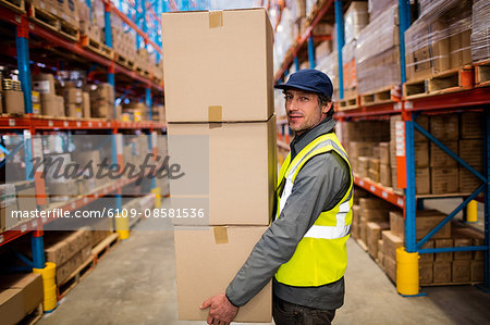 Warehouse worker carrying boxes