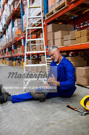 Worker lying and suffering on the floor