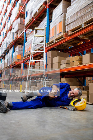 Worker lying and suffering on the floor