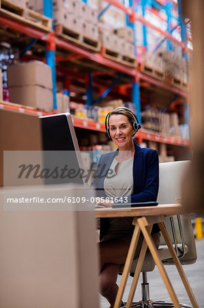 Portrait of warehouse manager working on her computer desk