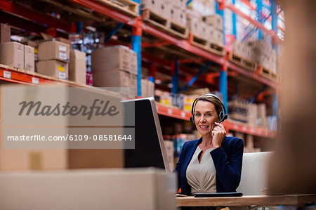 Warehouse manager talking with her headset