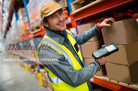 Warehouse worker using hand scanner