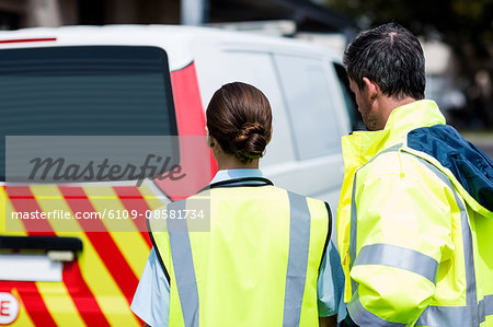 Ambulancemen turning back to the camera