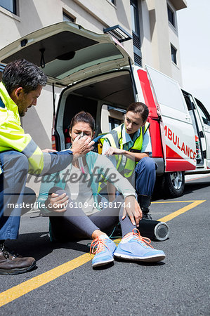 Ambulance men taking care of injured people
